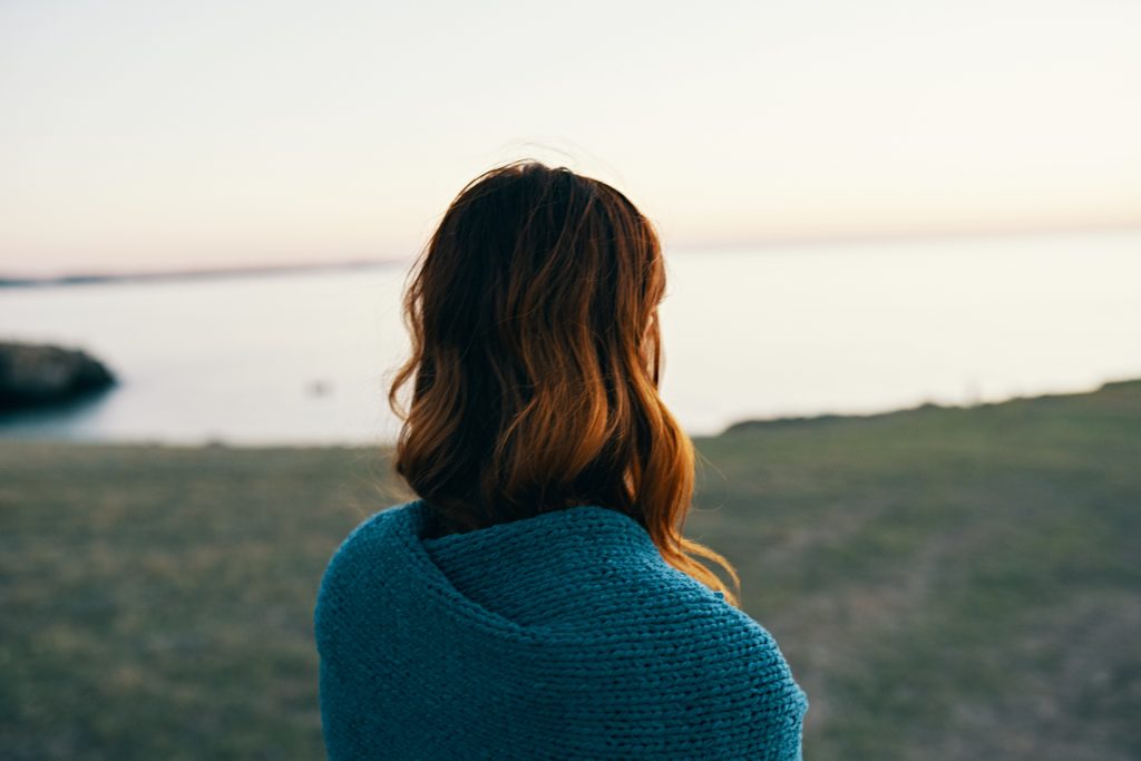 woman-in-nature-hiding-with-a-blanket-in-the-morni-2025-03-11-04-02-20-utc